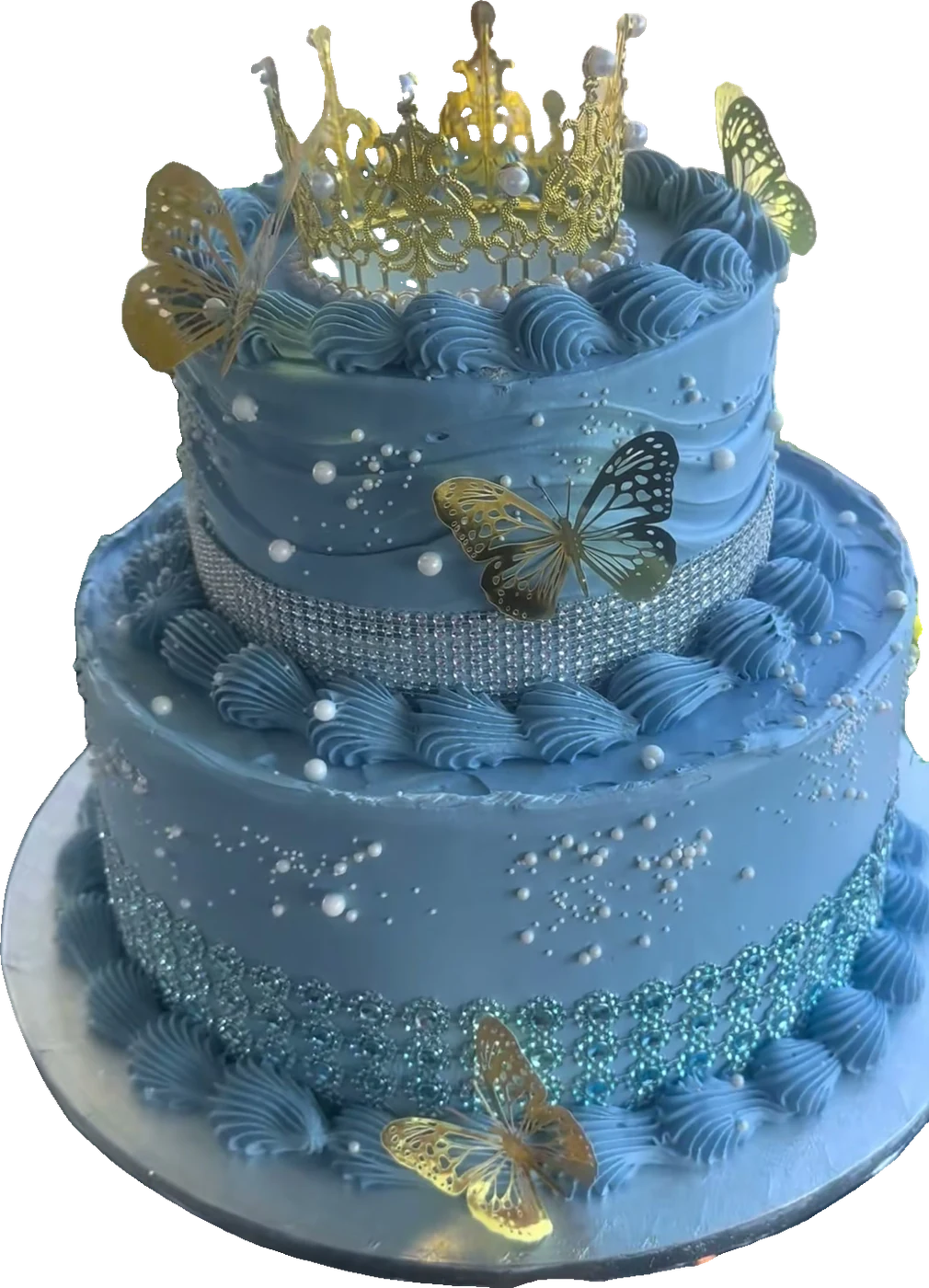 Two-tier dusty blue quinceañera cake with a gold crown