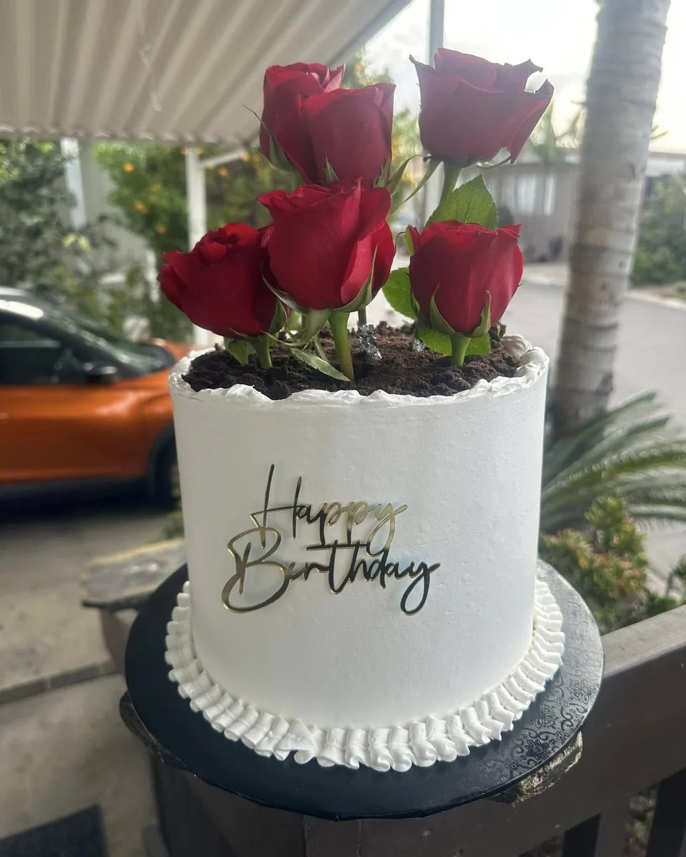 Rose Garden Cake: White buttercream crowned with fresh red roses