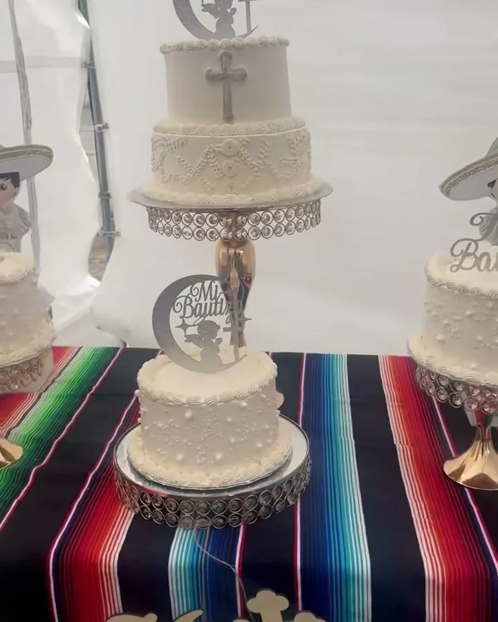 Charro-themed bautizo cakes on a sarape table runner