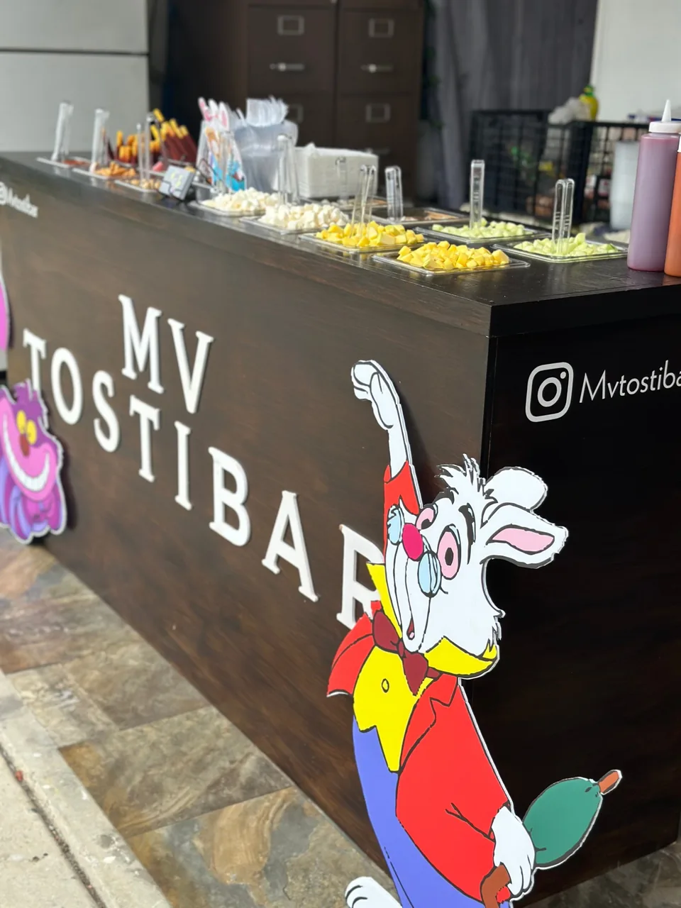 The MV Tostibar with a White Rabbit cutout and Cheshire Cat for an Alice in Wonderland party