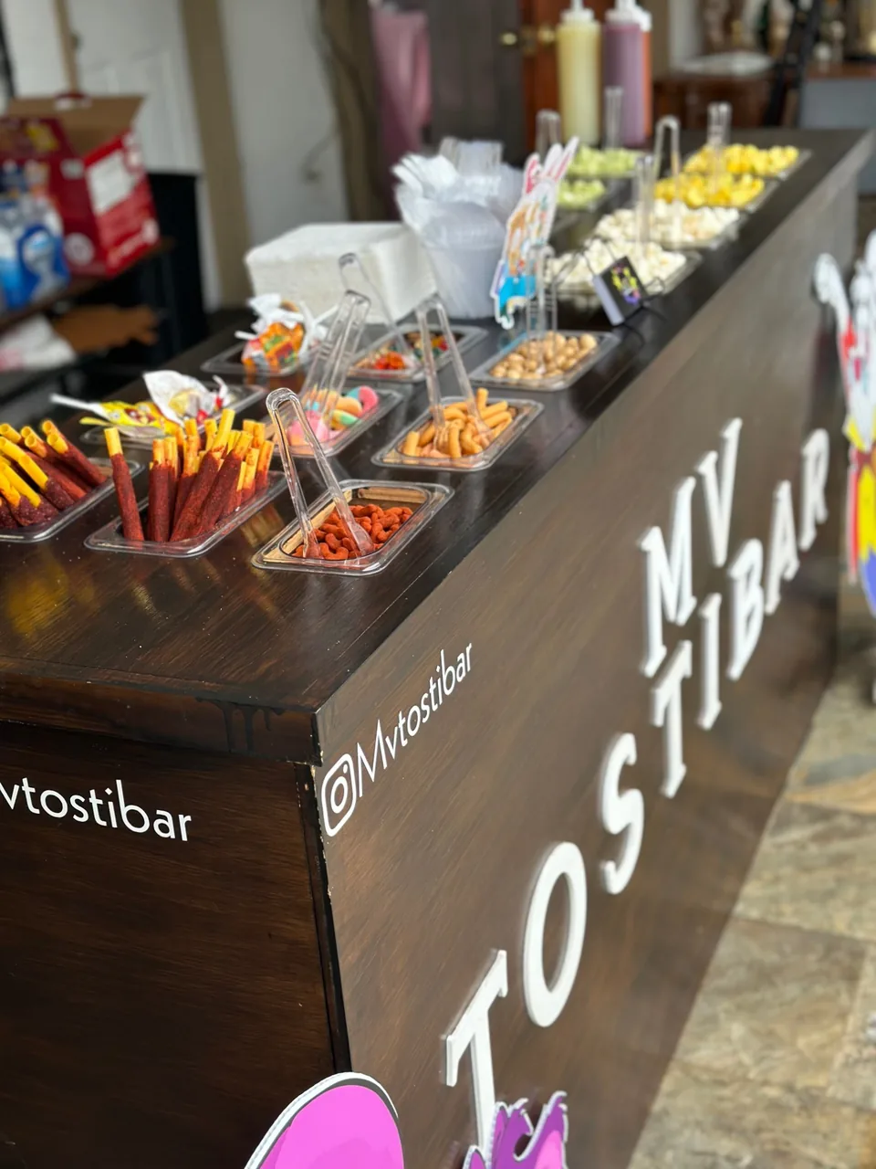 MV Tostibar with chamoy tamarind sticks, gummies, Japanese peanuts and fresh fruit