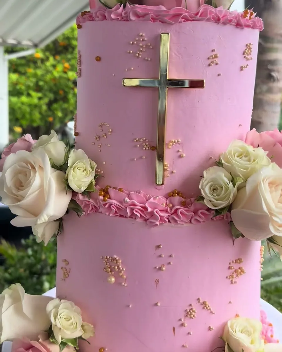 Pink bautizo cake with roses and gold cross